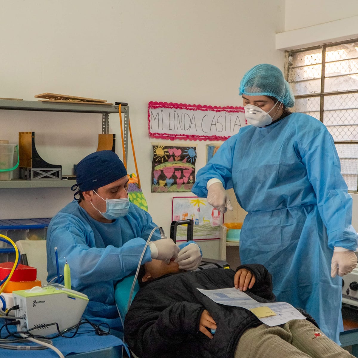 pre dental student assiting local dentist in a mobile clinic