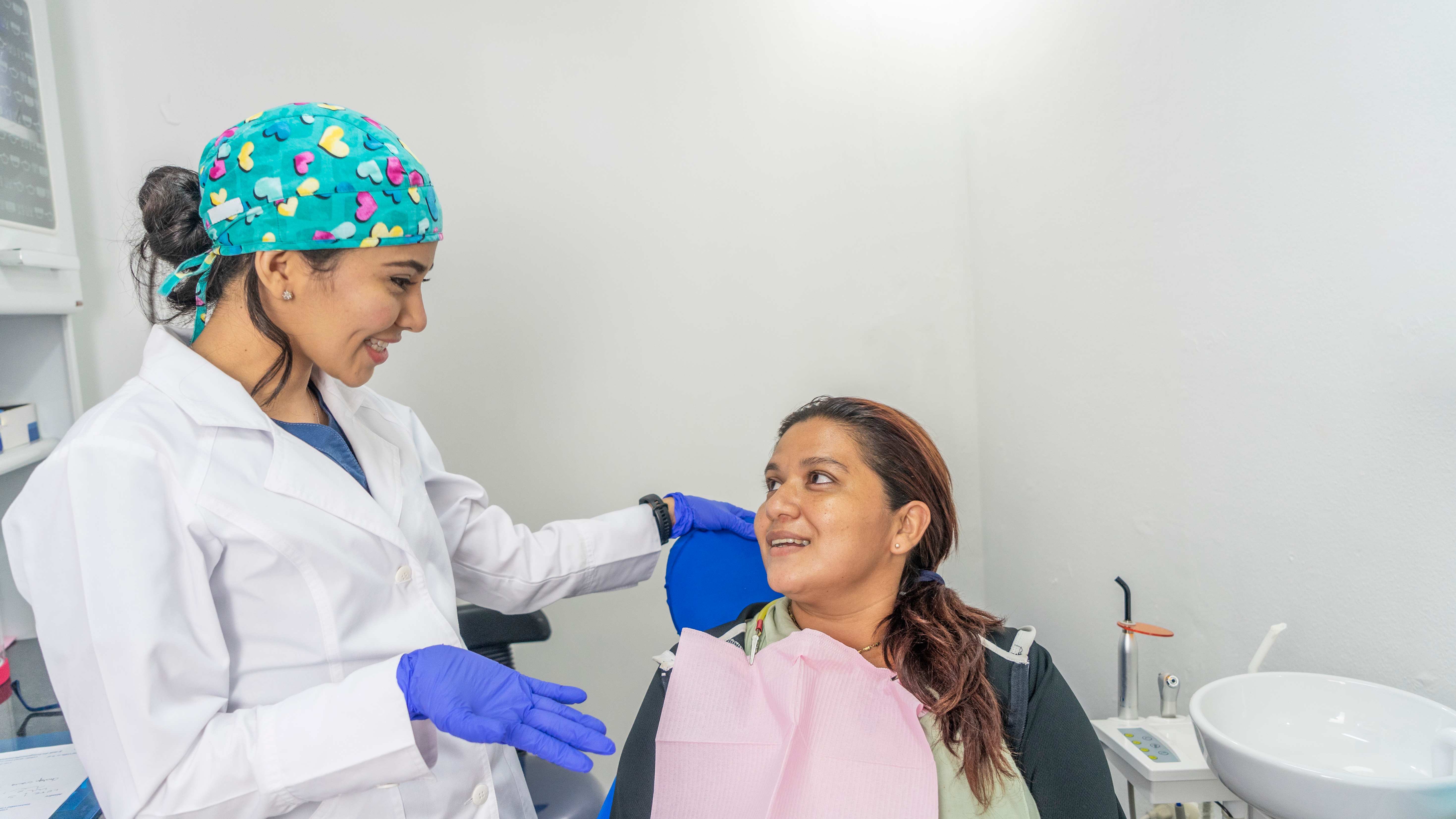 young-hispanic-dentist-examining-her-patient-2025-02-02-20-58-29-utc